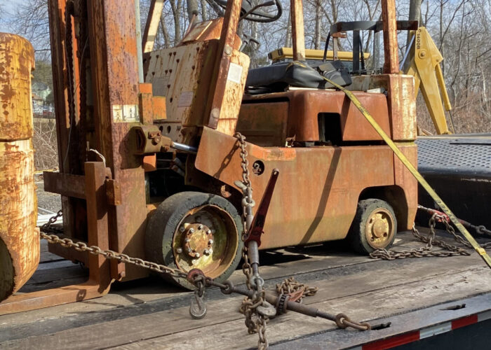 orange warehouse forklift on truck