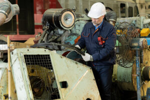 mechanic removing parts off machinery